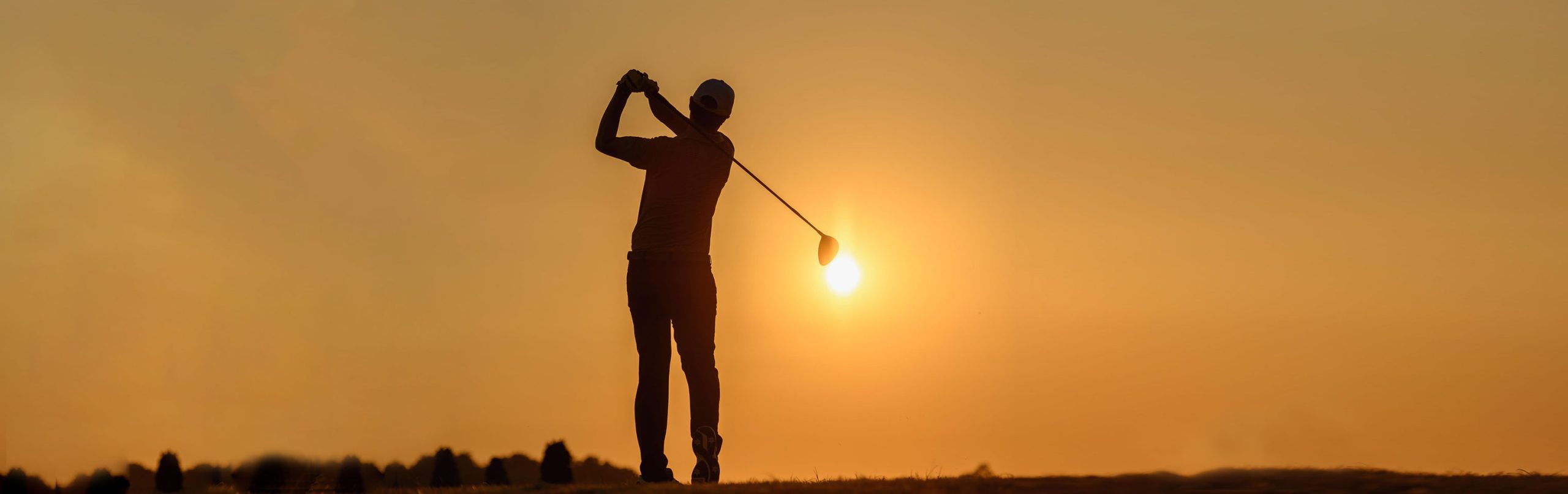 Golfer at sunset
